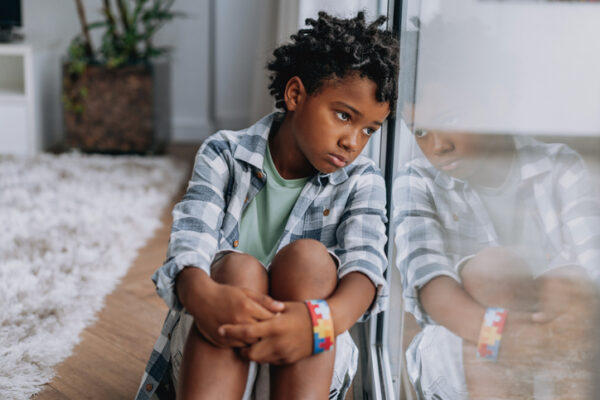 Child looking through window.